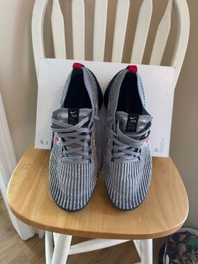 Nike Gray Flyknit Sneakers with Red Heel Tab